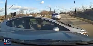Police vehicle pursuing car on road