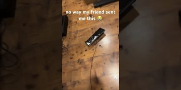 Broken keyboard on wooden floor with caption overlay.