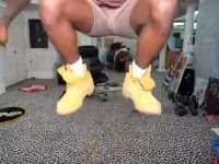 Person jumping indoors with boots on carpet