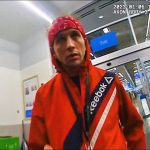 Person in red jacket at store entrance