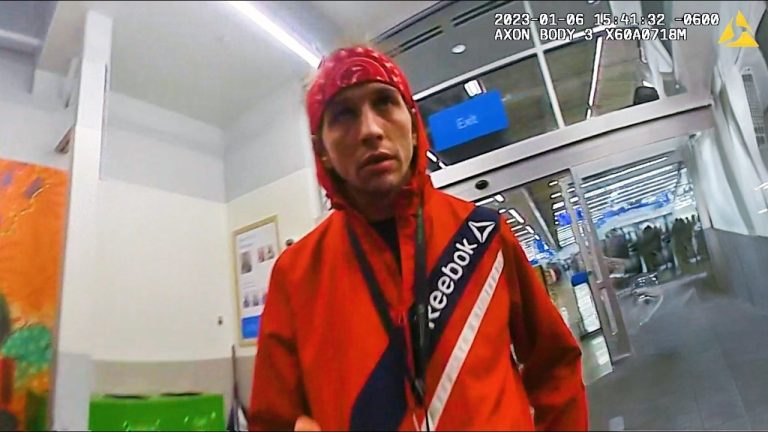 Person in red jacket at store entrance