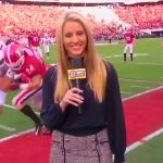 Reporter on football field during game.