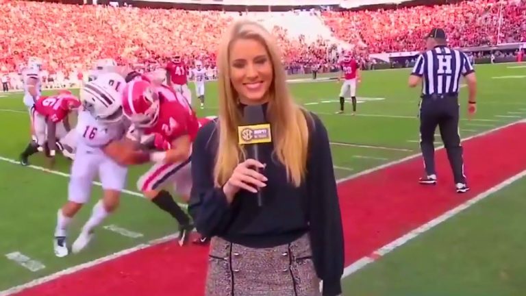 Reporter on football field during game.