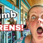 Surprised woman in front of a shop.