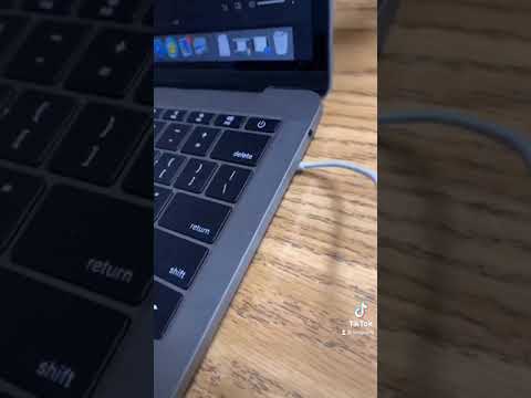 MacBook Pro connected, desktop screen visible.