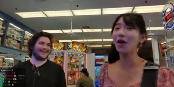 Two people enjoying arcade games indoors.