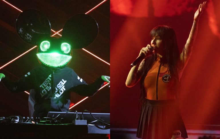 DJ in mask and singer performing live on stage.