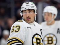 Hockey player on ice in Boston Bruins jersey.
