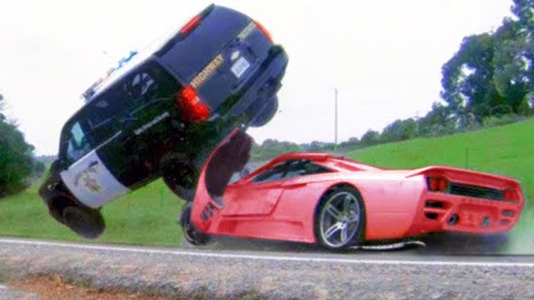 Police SUV collides with red sports car.