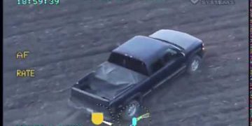 Aerial view of police-tracked pickup truck.