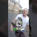 Motorcyclist gesturing towards a man on the street.