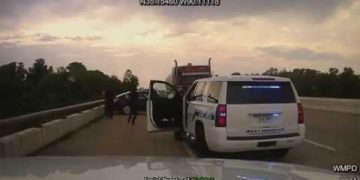 Police cars on highway with open doors.