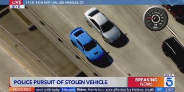Aerial view of police chase on highway.