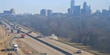 Highway scene with city skyline in background