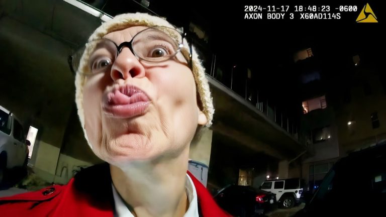 Person making a funny face near car at night.