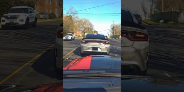 Cars driving on suburban road, sunny day