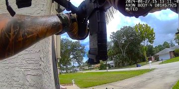 Body cam view of armed person outside home.