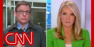 CNN news anchors reporting live on television