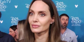 People at D23 Expo event backdrop