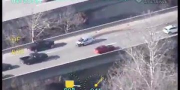 Helicopter footage of car chase on highway.