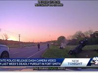 Police dashcam captures flipped car at sunset roadside.