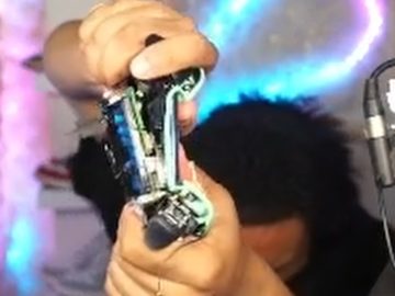 Person breaking gaming controller in frustration.