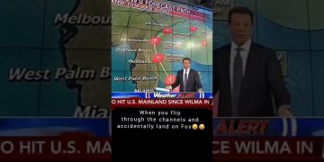 Meteorologist forecasts hurricane path on TV screen.