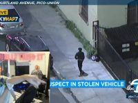 Surveillance footage shows suspect near stolen vehicle.