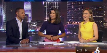 News anchors discussing trending topics on set.