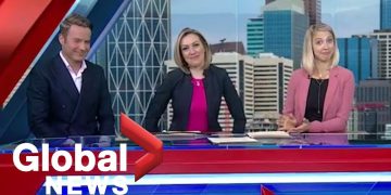 Global News anchors at broadcast desk.