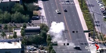 Car crash on busy urban intersection, aerial view.