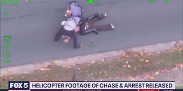 Police arrest suspect, helicopter footage from above.
