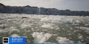 Glacier with floating ice chunks in water