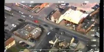 Aerial view of busy urban intersection with cars.
