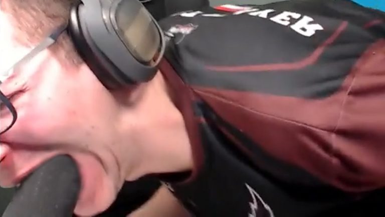 Person wearing headset bites foam microphone cover.