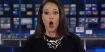 Surprised woman in TV studio, wide-eyed expression.