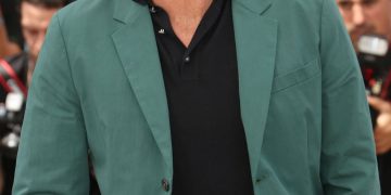 Person in green jacket at outdoor event