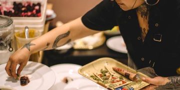 Chef plating dishes with creative design.