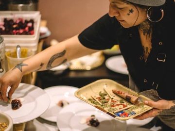 Chef plating dishes with creative design.
