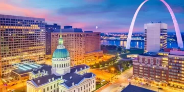 St. Louis skyline with Gateway Arch at sunset.