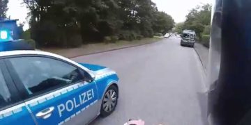 Police car on road beside motorcycle