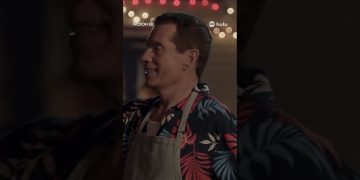 Smiling person in apron at night scene.