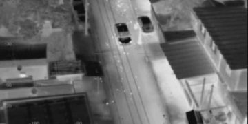 Thermal aerial view of road and two cars.