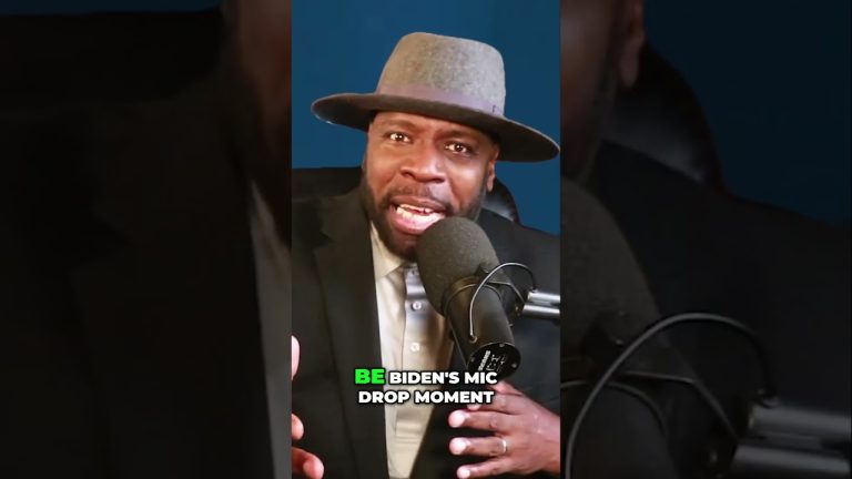 Man speaking into a microphone, wearing a hat.