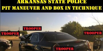 Arkansas police cars perform PIT maneuver on road.