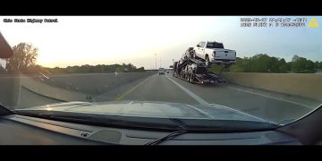 Cars on highway transporter, view from dashboard camera.