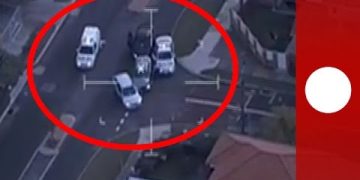 Aerial view of police cars stopping vehicle.