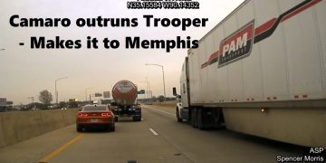 Camaro speeding past trucks on highway to Memphis.
