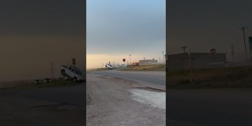 Van crashed off road near intersection.