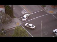 Aerial view of two cars at an intersection.